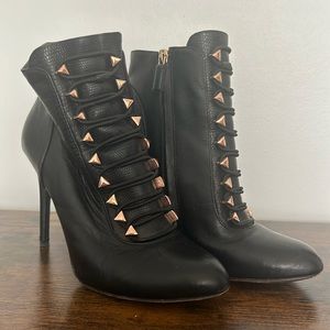 BCBG ankle booties with metal detail.